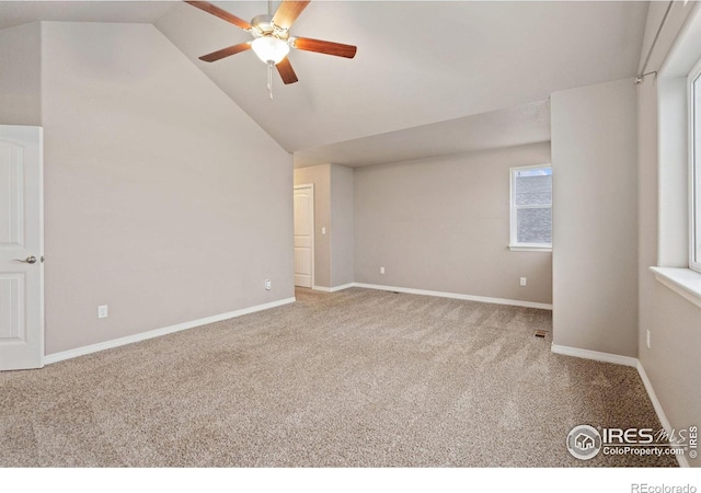 carpeted empty room with vaulted ceiling and ceiling fan