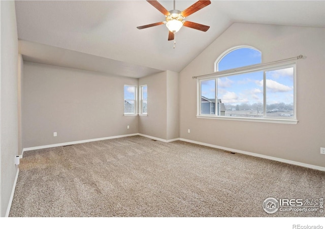 spare room with ceiling fan, carpet, and vaulted ceiling