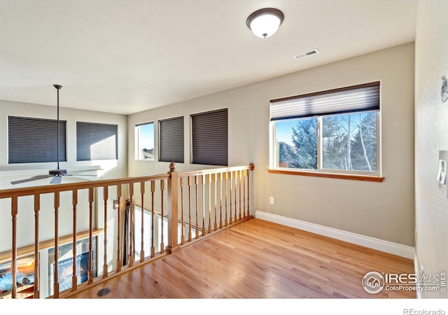 hallway with light hardwood / wood-style floors