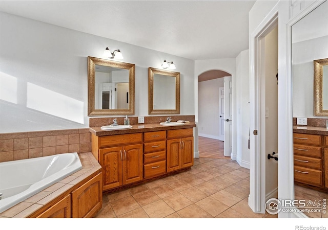 bathroom featuring vanity, a bathing tub, and tile patterned flooring