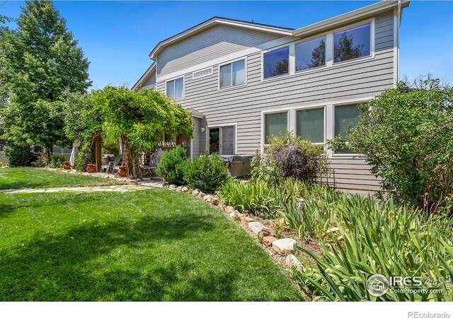 rear view of house with a lawn