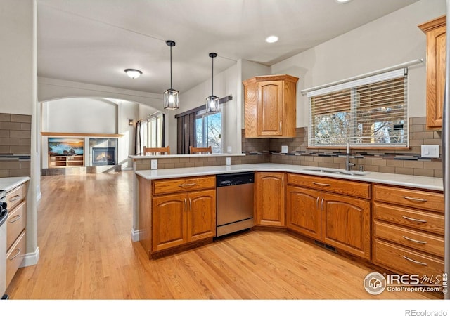 kitchen with dishwasher, sink, pendant lighting, and decorative backsplash