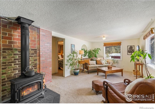 carpeted living room featuring plenty of natural light and a textured ceiling