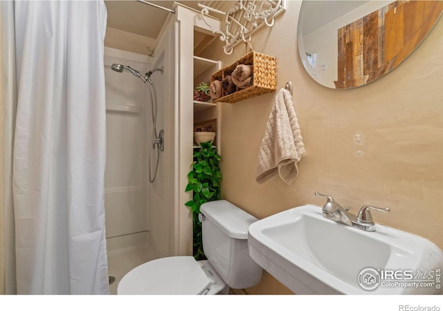 bathroom with toilet, walk in shower, and sink