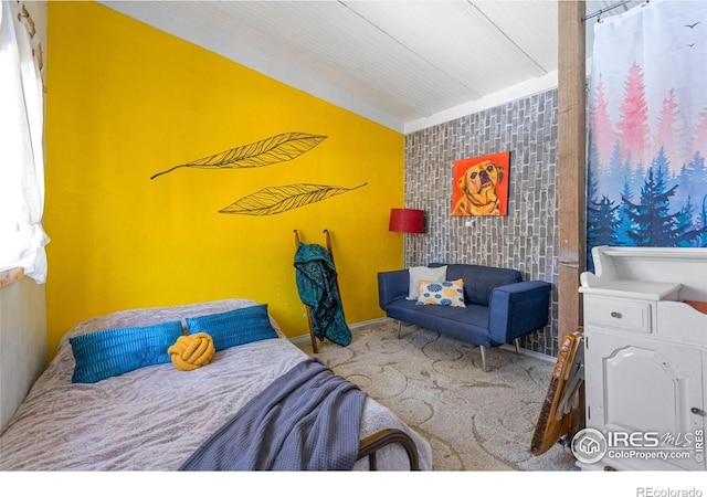 bedroom featuring carpet and vaulted ceiling