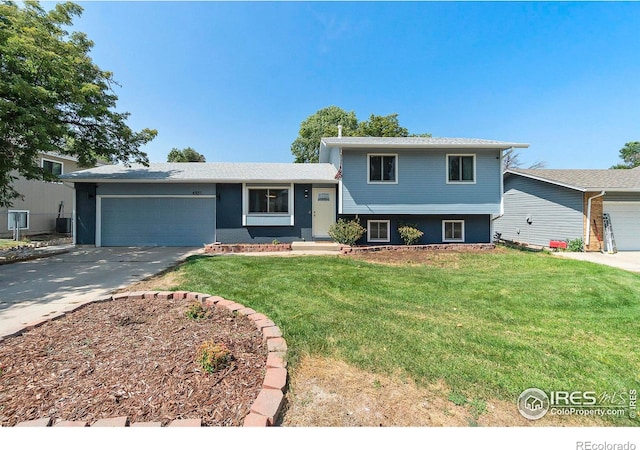 split level home with a front yard and a garage