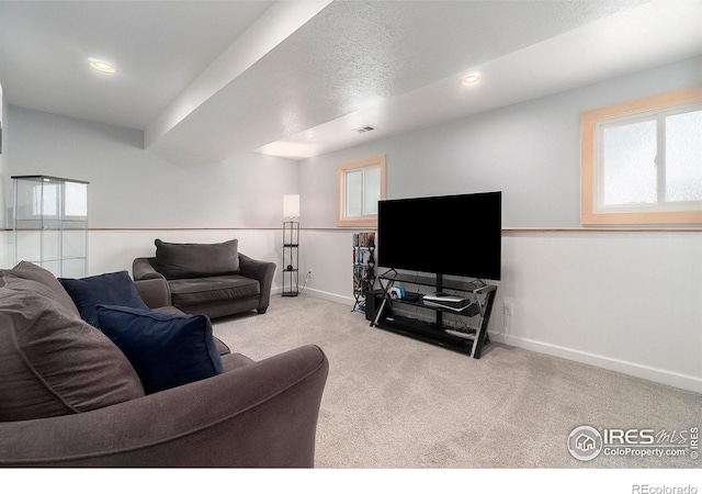 living room with light carpet and a textured ceiling