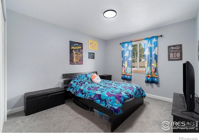 carpeted bedroom with a textured ceiling