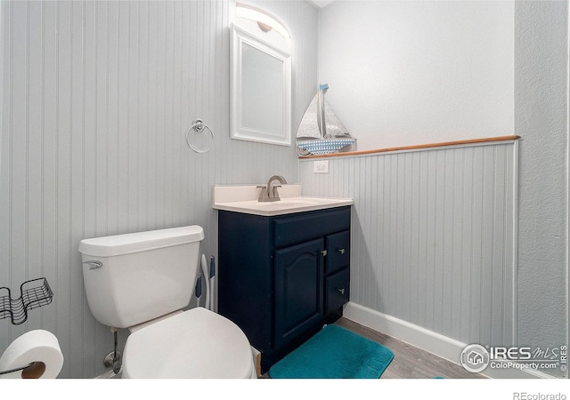 bathroom featuring hardwood / wood-style floors, vanity, and toilet