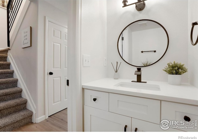 bathroom with vanity and wood finished floors