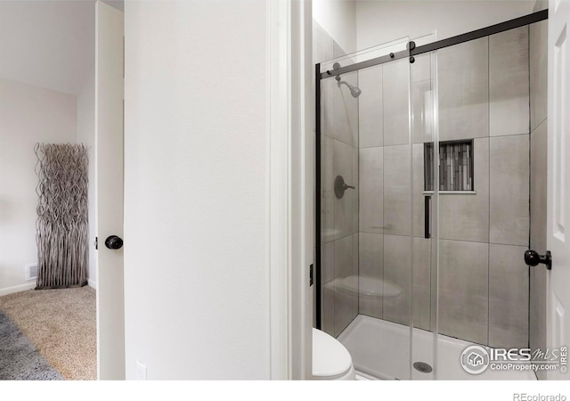 full bathroom with a shower stall and toilet