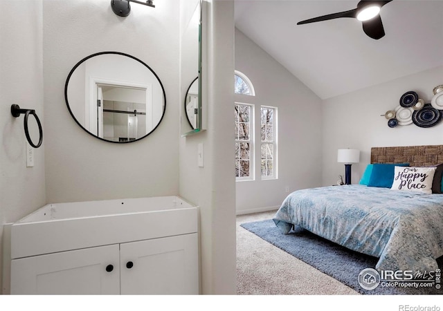 bedroom featuring light carpet, vaulted ceiling, and a ceiling fan