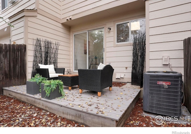 wooden deck with central air condition unit, fence, and an outdoor hangout area