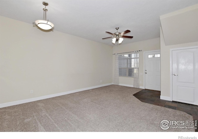 carpeted foyer entrance with ceiling fan