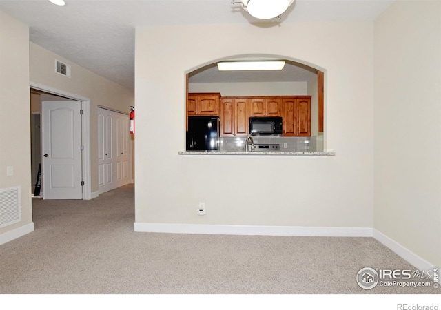 kitchen featuring black appliances and sink