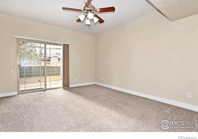 carpeted spare room featuring ceiling fan