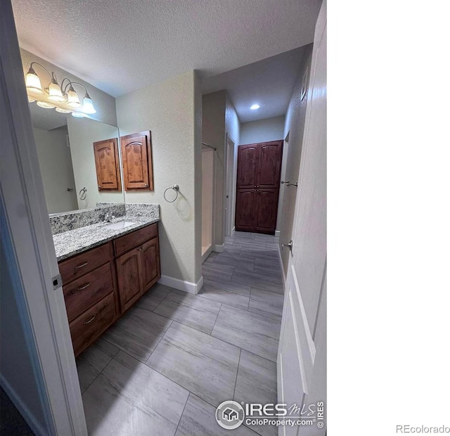 bathroom with vanity and a textured ceiling