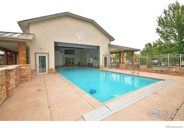 view of swimming pool with a patio area