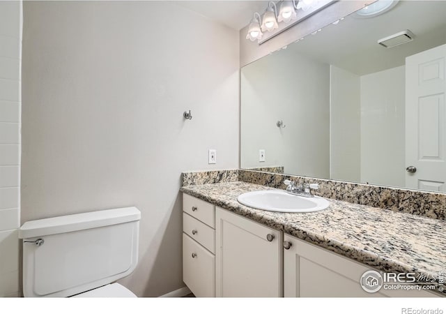 bathroom with vanity and toilet