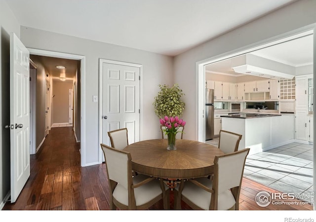 dining space with wood-type flooring