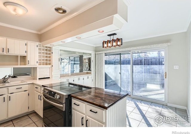 kitchen featuring crown molding, sink, electric range, white cabinetry, and light tile patterned flooring