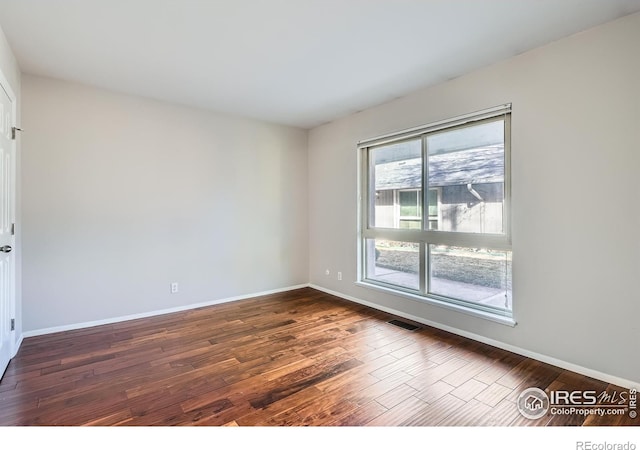 empty room featuring dark hardwood / wood-style floors