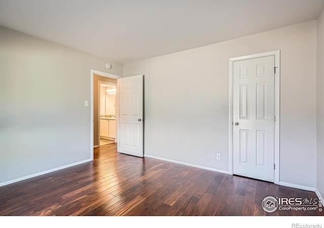 unfurnished bedroom featuring dark hardwood / wood-style floors