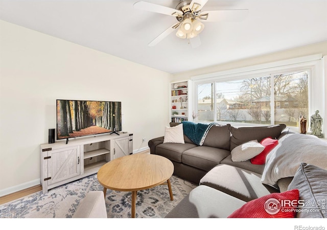 living room featuring ceiling fan and wood-type flooring