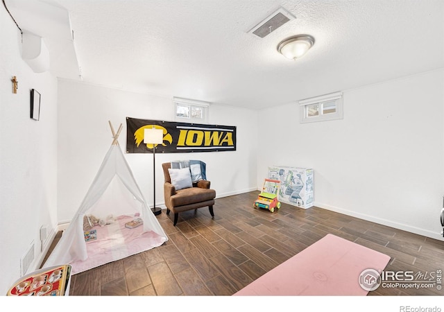 living area with a textured ceiling