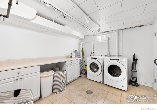 washroom with cabinets and independent washer and dryer