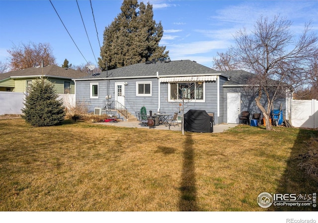 rear view of property featuring a lawn and a patio