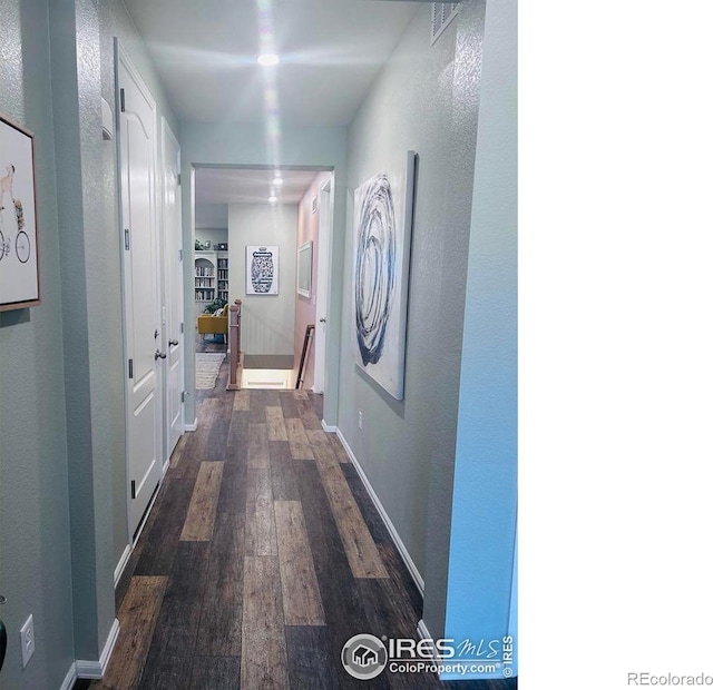 corridor featuring dark hardwood / wood-style floors