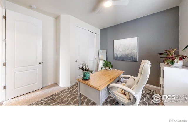 office area with ceiling fan and light carpet