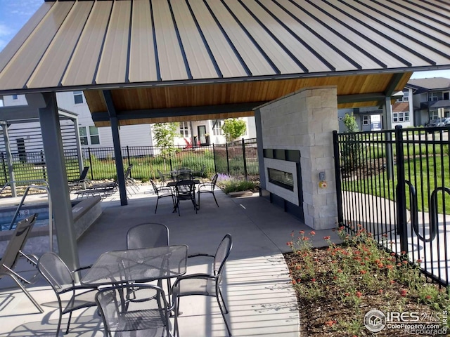 view of patio / terrace with a gazebo and a tile fireplace