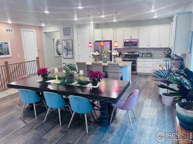 dining room with dark wood-type flooring