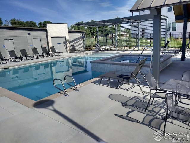 view of swimming pool featuring a patio area and a hot tub