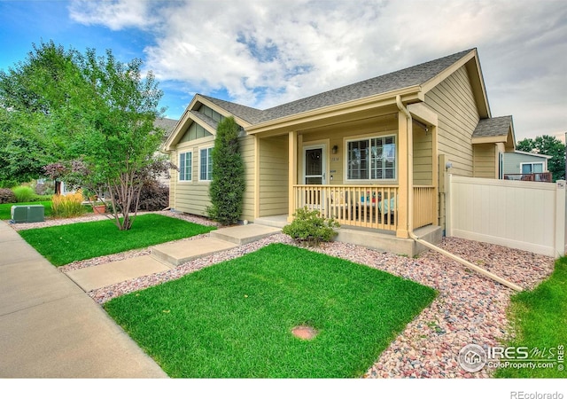 view of front of home featuring covered porch and a front lawn