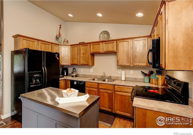 kitchen featuring black appliances, sink, vaulted ceiling, dark hardwood / wood-style floors, and a kitchen island