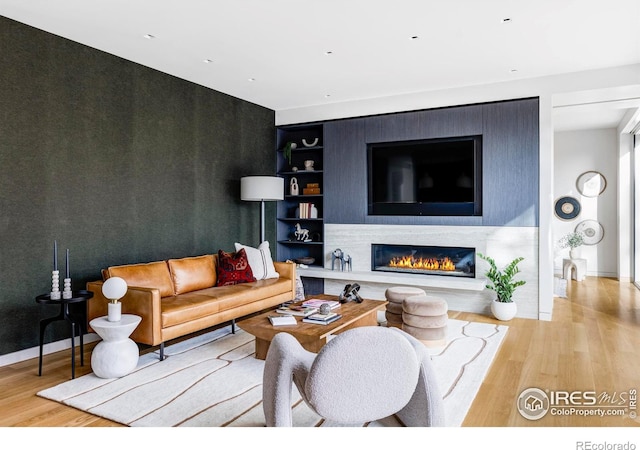 living room featuring light hardwood / wood-style flooring and built in features