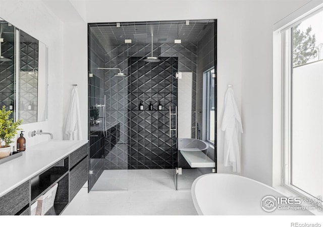 bathroom featuring tile patterned flooring, vanity, and separate shower and tub