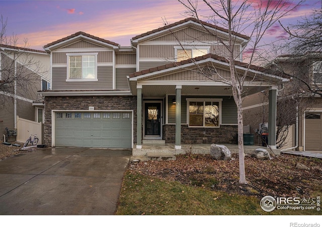 view of front of home featuring a porch and a garage