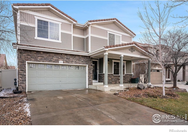 view of front of home featuring a porch and a garage