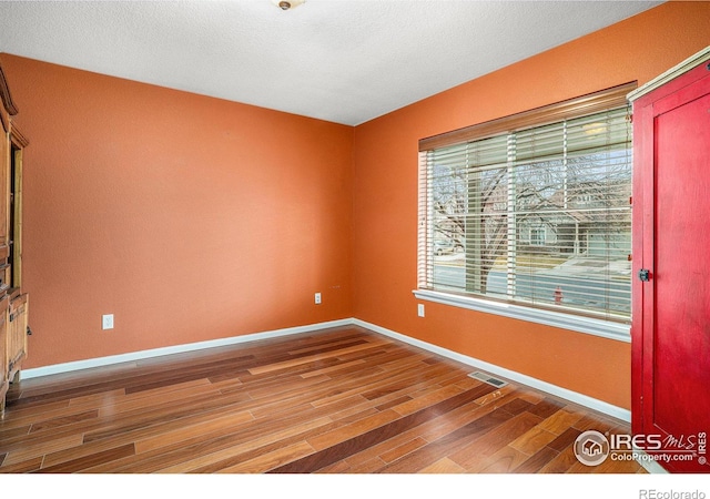 empty room featuring wood-type flooring