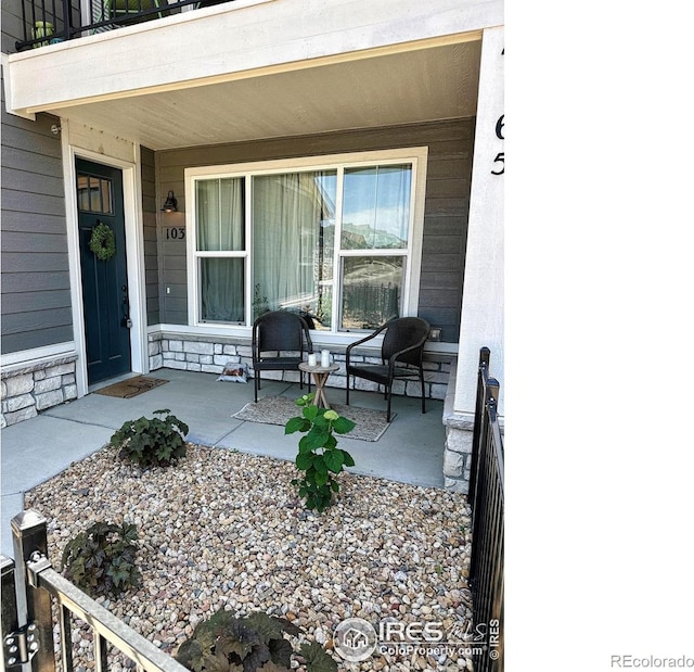 view of patio featuring a porch and a balcony