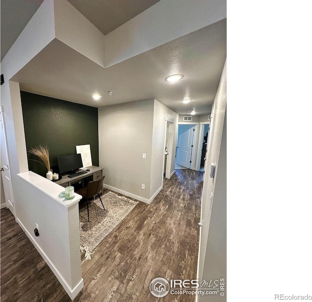 office with dark hardwood / wood-style flooring and a textured ceiling