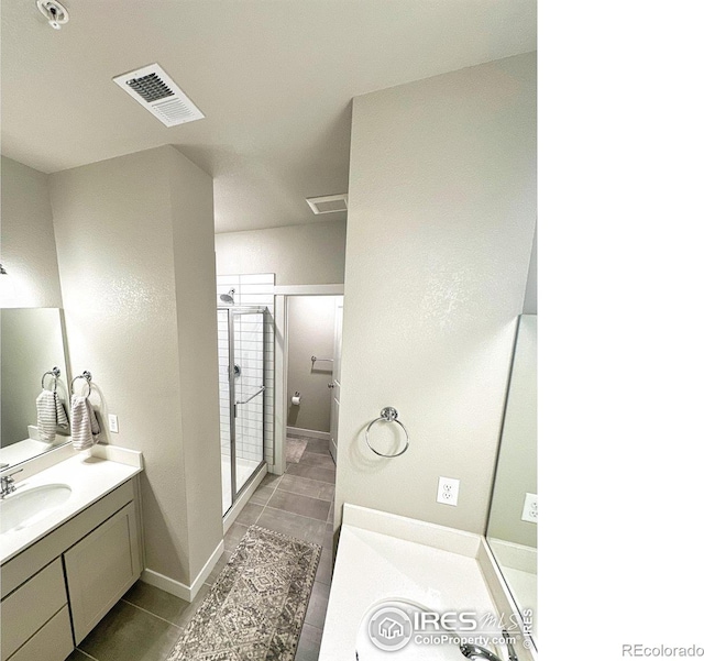 bathroom with tile patterned flooring, vanity, and an enclosed shower