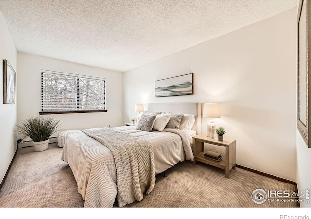 bedroom featuring carpet and a textured ceiling