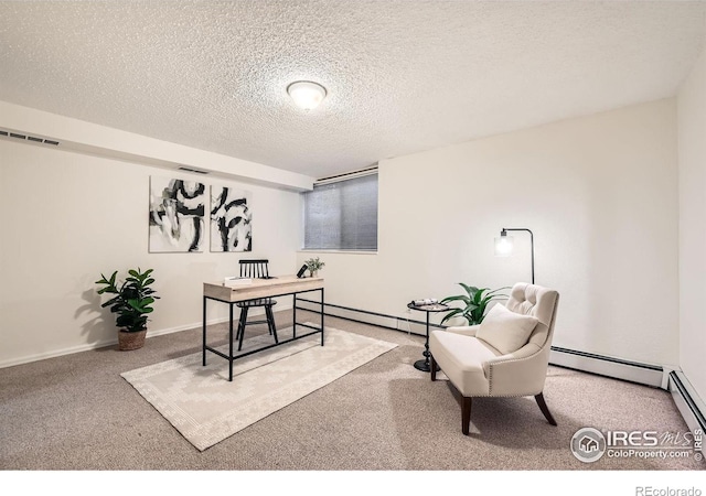 carpeted office space with a textured ceiling and a baseboard heating unit