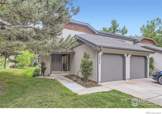 view of front of property with a garage and a front yard