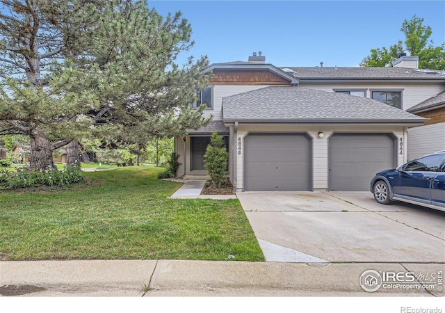 view of front of property with a front lawn and a garage